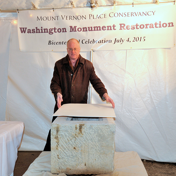 Lance Humphries, Chair of Restoration Committee, Mount Vernon Place Conservancy unveiling the content of the 1815 time capsule at the base of the monument on February 18, 2015.