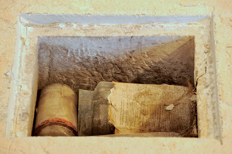 First glimpse at the contents of the hollowed well within the cornerstone was in line with the 1815 account of the foundation-laying ceremony: glass bottles, newspapers of the days, with more historical artifacts yet to be revealed.