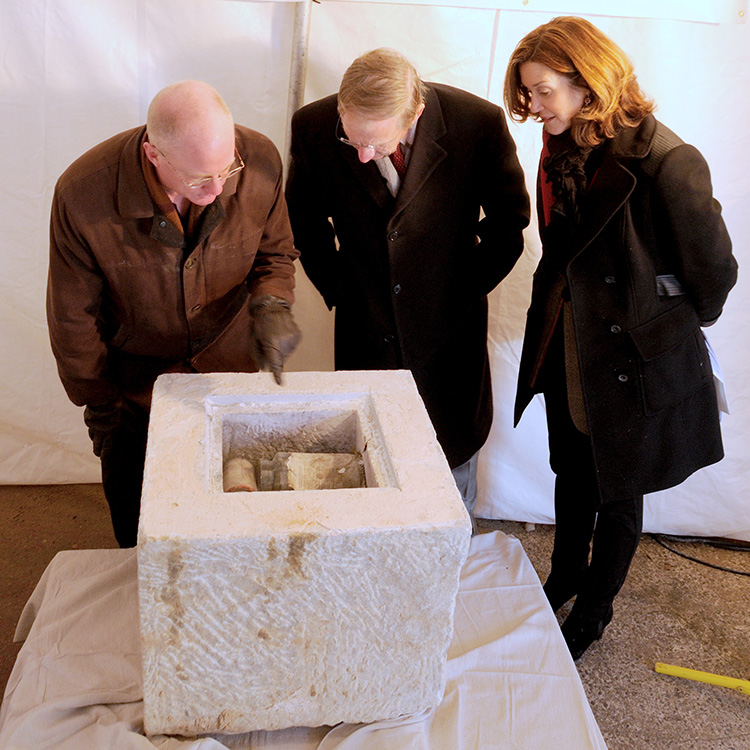 Mount Vernon Place Conservancy officials examining 1815 artifacts: Lance Humphries, Chair of Restoration Committee, Richard Thomas, Head of the Development Committee, and Faith Millspaugh, Vice President and Bicentennial Co-Chair.